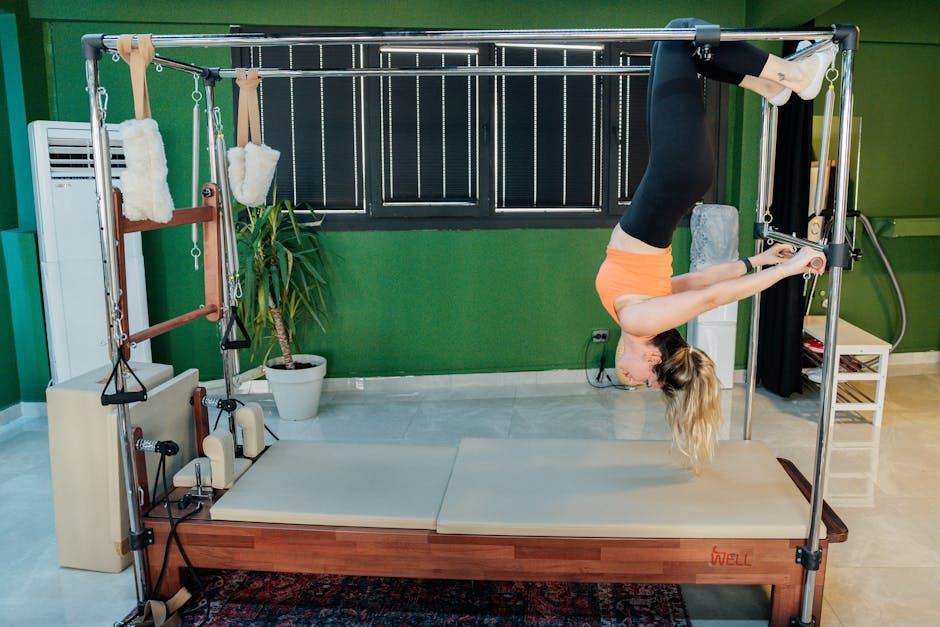 Woman practicing reformer pilates exercise in a modern fitness studio